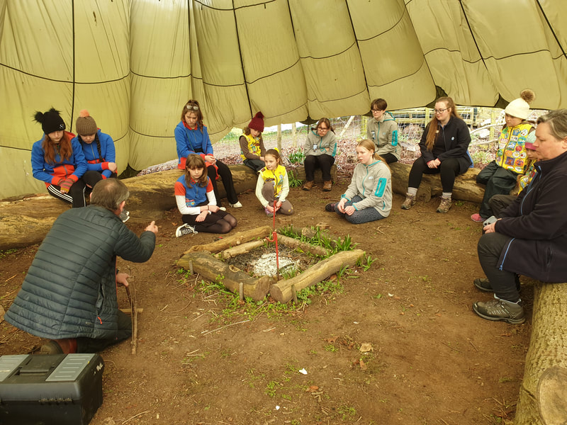 Bushcraft - A group of Brownies and Guides in the bushcraft area listening to the instructor
