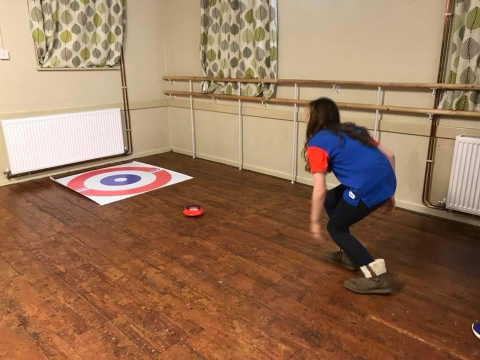 Indoor Curling - A guide taking part in curling in a village hall