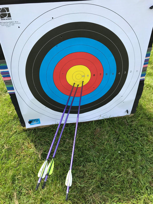 Archery - Three arrows in the yellow circle of the archery target